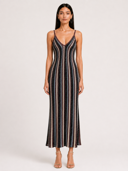 A woman wearing the Elévaison Viola Moonlit Cocoa Stripe sequin-knit V-neck maxi dress, viewed from the front against a light gray studio background.