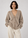 Model wearing the Khaki Elévaison Alina Cardigan with a V-neck button front and ribbed trim against a pale gray studio backdrop.