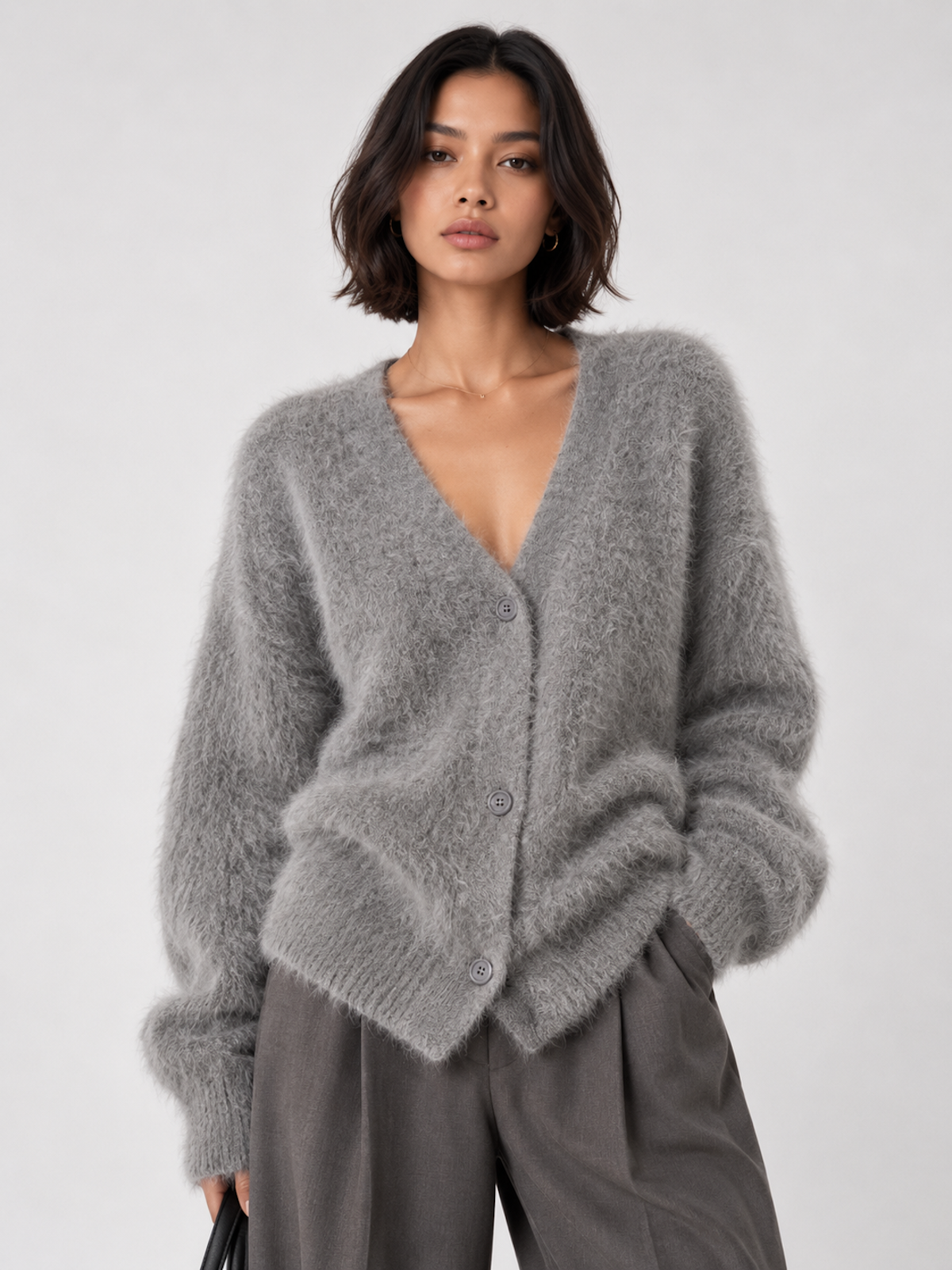 Front view of the gray Elévaison Alina Cardigan with a V-neck, button front and ribbed trim against a light gray seamless backdrop.