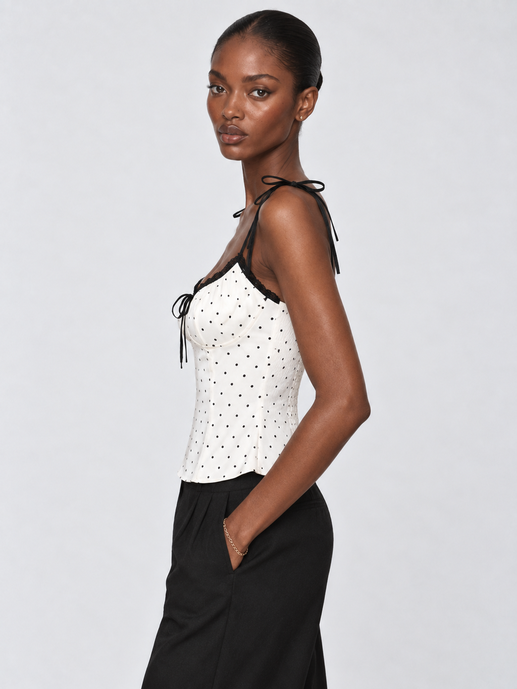 Side view of the Porcelain Microdot Elévaison Elowen Sleeveless Top with shoulder ties and a fitted corset-inspired shape.