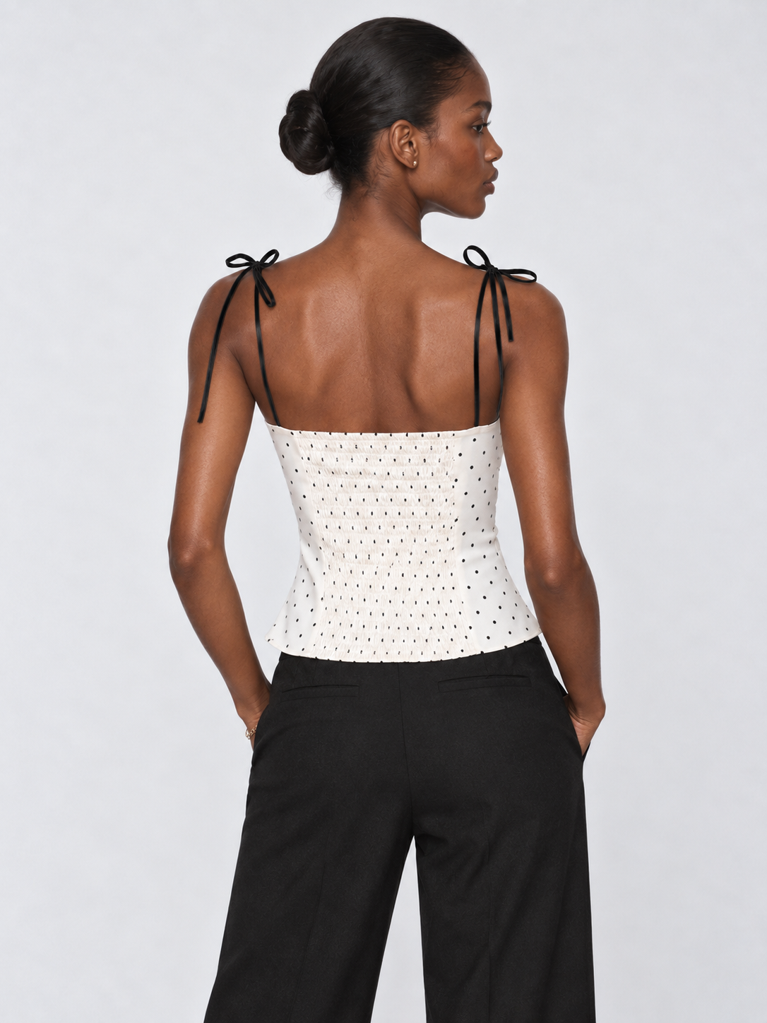 Back view of the Porcelain Microdot Elévaison Elowen Sleeveless Top, showing the open back and shoulder ties in studio.
