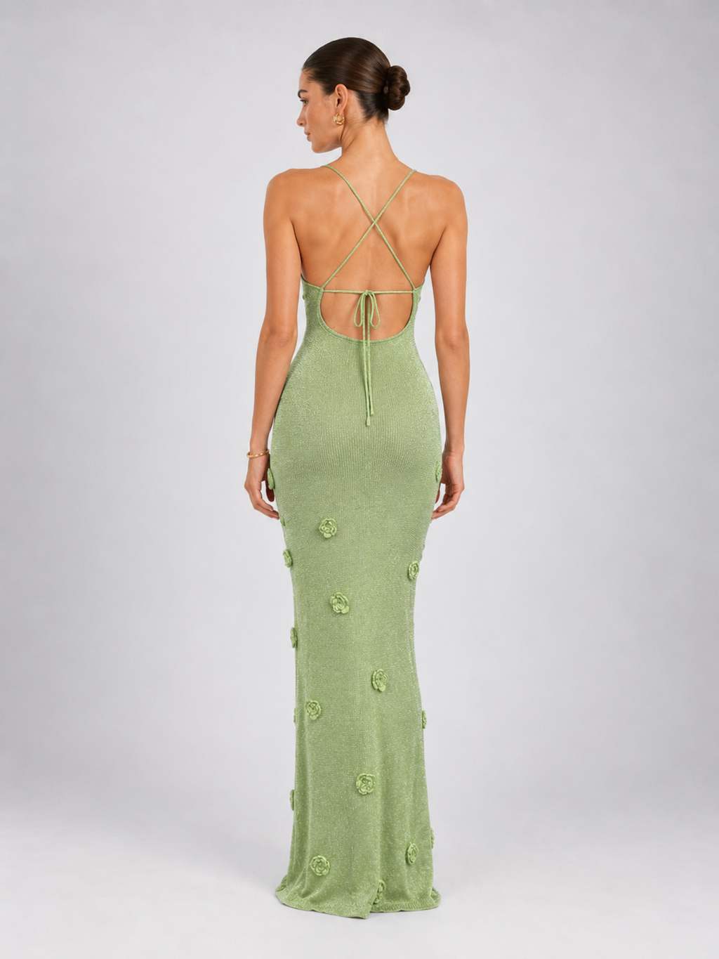 Side view of the Light Green Elévaison Sabella Dress, showing its fitted maxi shape and floral appliqué details.