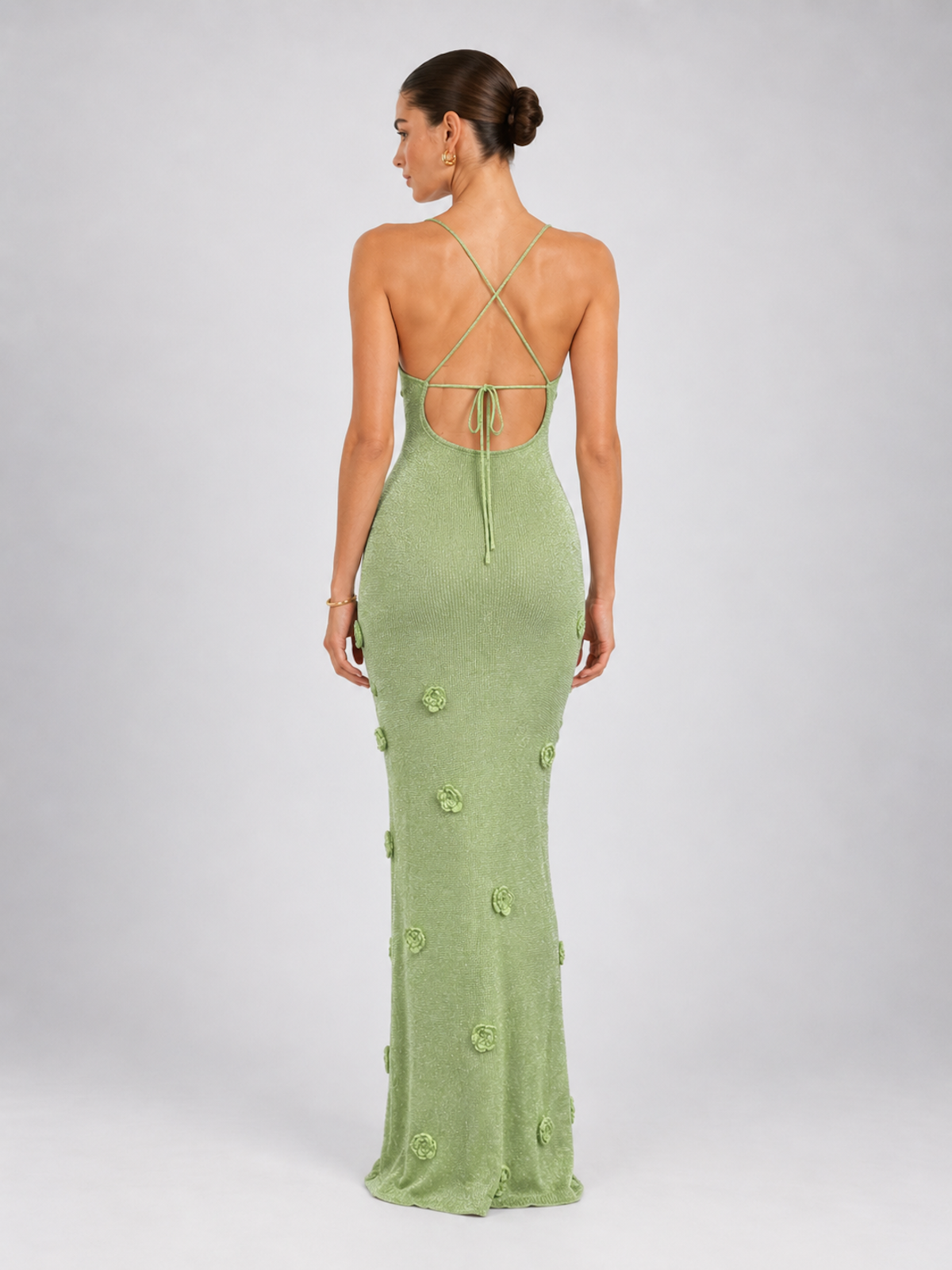 Side view of the Light Green Elévaison Sabella Dress, showing its fitted maxi shape and floral appliqué details.