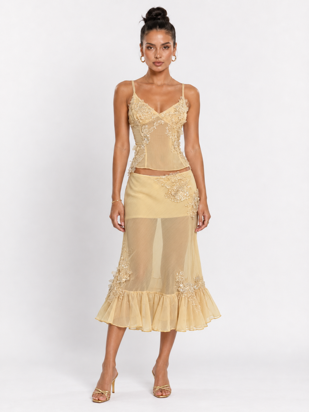 Model wearing the Yellow Elévaison Valentina Two Piece with a fitted lace-trim camisole and ruffled midi skirt in studio.