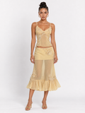 Model wearing the Yellow Elévaison Valentina Two Piece with a fitted lace-trim camisole and ruffled midi skirt in studio.