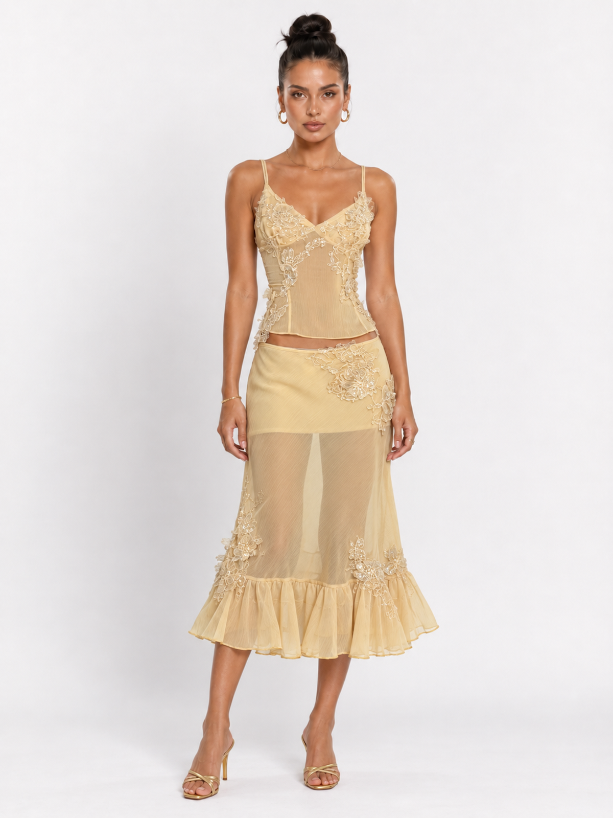 Model wearing the Yellow Elévaison Valentina Two Piece with a fitted lace-trim camisole and ruffled midi skirt in studio.