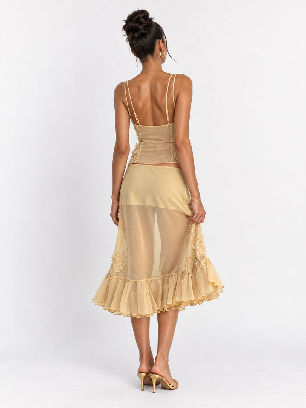 Back view of the Yellow Elévaison Valentina Two Piece, showing the camisole straps and ruffled midi skirt in studio.