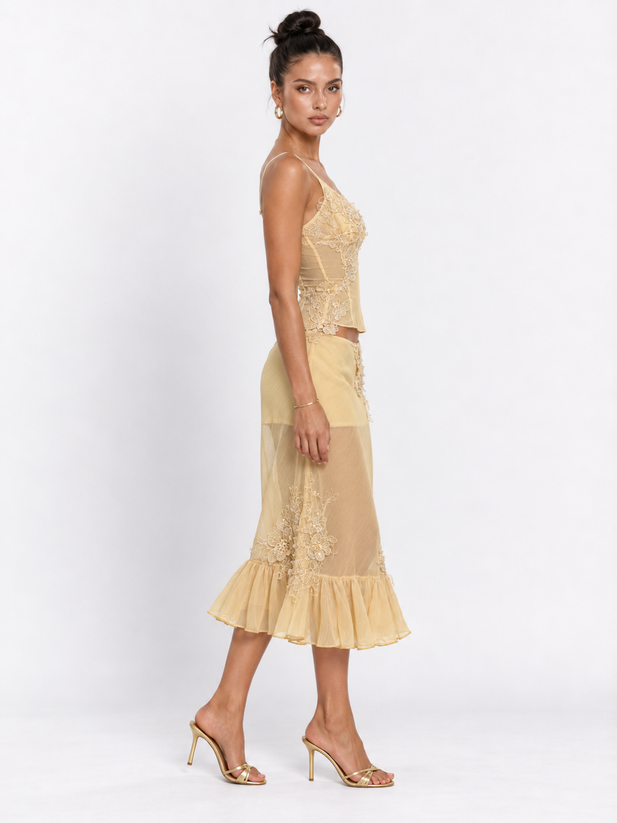 Side view of the Yellow Elévaison Valentina Two Piece with a fitted camisole, sheer skirt panels and ruffled hem.