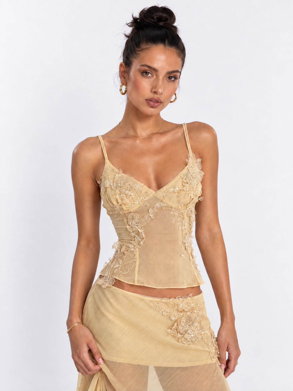 Model wearing the Yellow Elévaison Valentina Two Piece, highlighting the embellished camisole and ruffled skirt in studio.