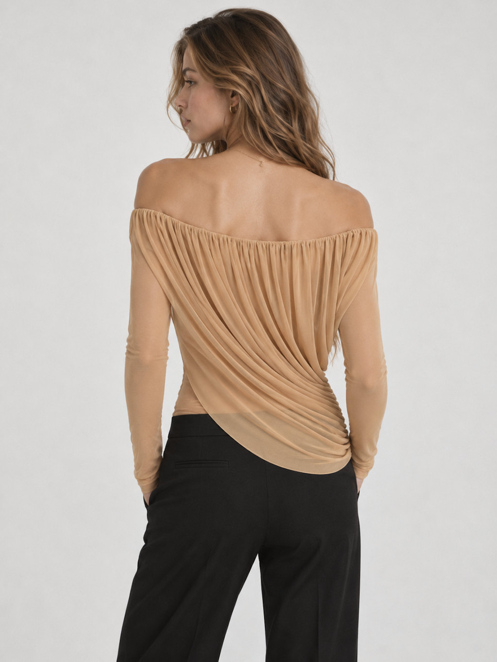 Model wearing the White Elévaison Ines Long-Sleeve Top with an off-shoulder neckline and gathered asymmetric drape.
