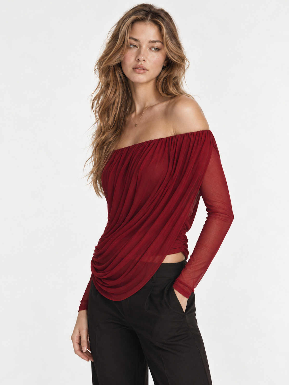 Model wearing the Elévaison Ines Long-Sleeve Top with gathered drape and an open off-shoulder back in a pale gray studio.