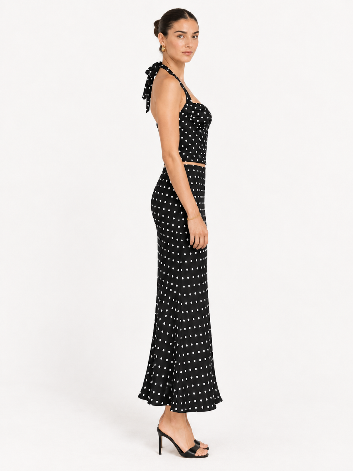 Side view of the Midnight Polka Elévaison Thalia Two Piece with an exposed waistline and fitted flared skirt in studio.