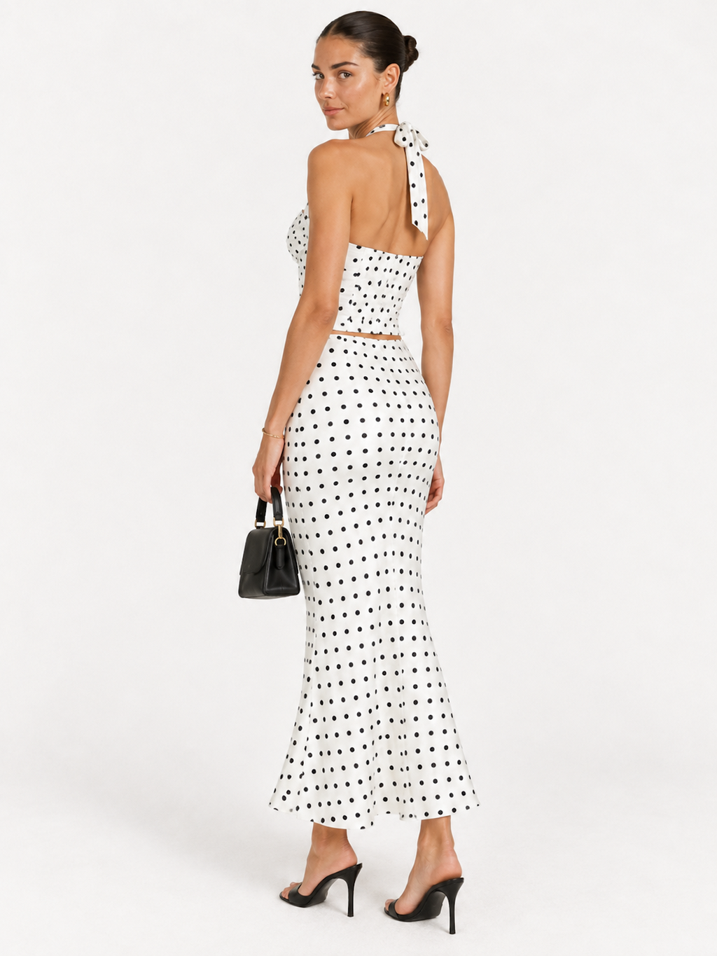 Side view of the Daylight Polka Elévaison Thalia Two Piece with an exposed waistline and fitted flared skirt in studio.