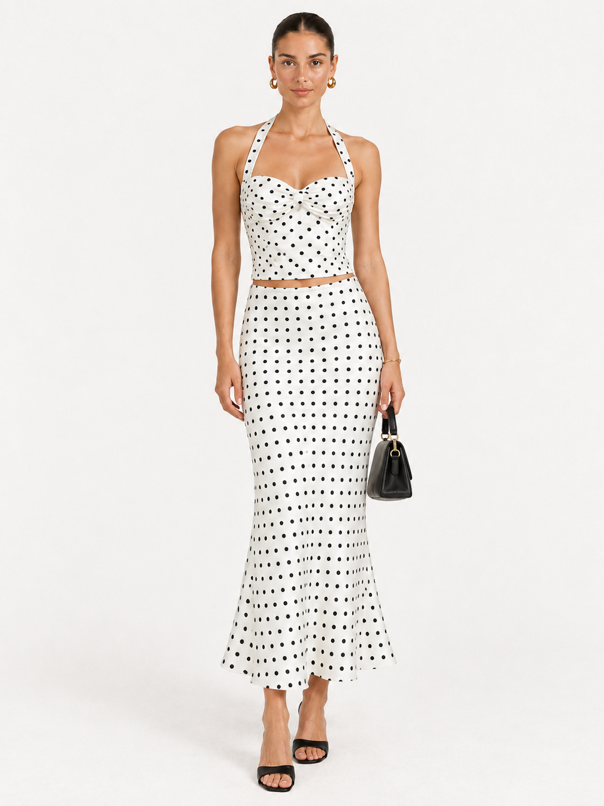 Front view of the Daylight Polka Elévaison Thalia Two Piece with a back-tie halter top and flared midi skirt against a light gray seamless backdrop.
