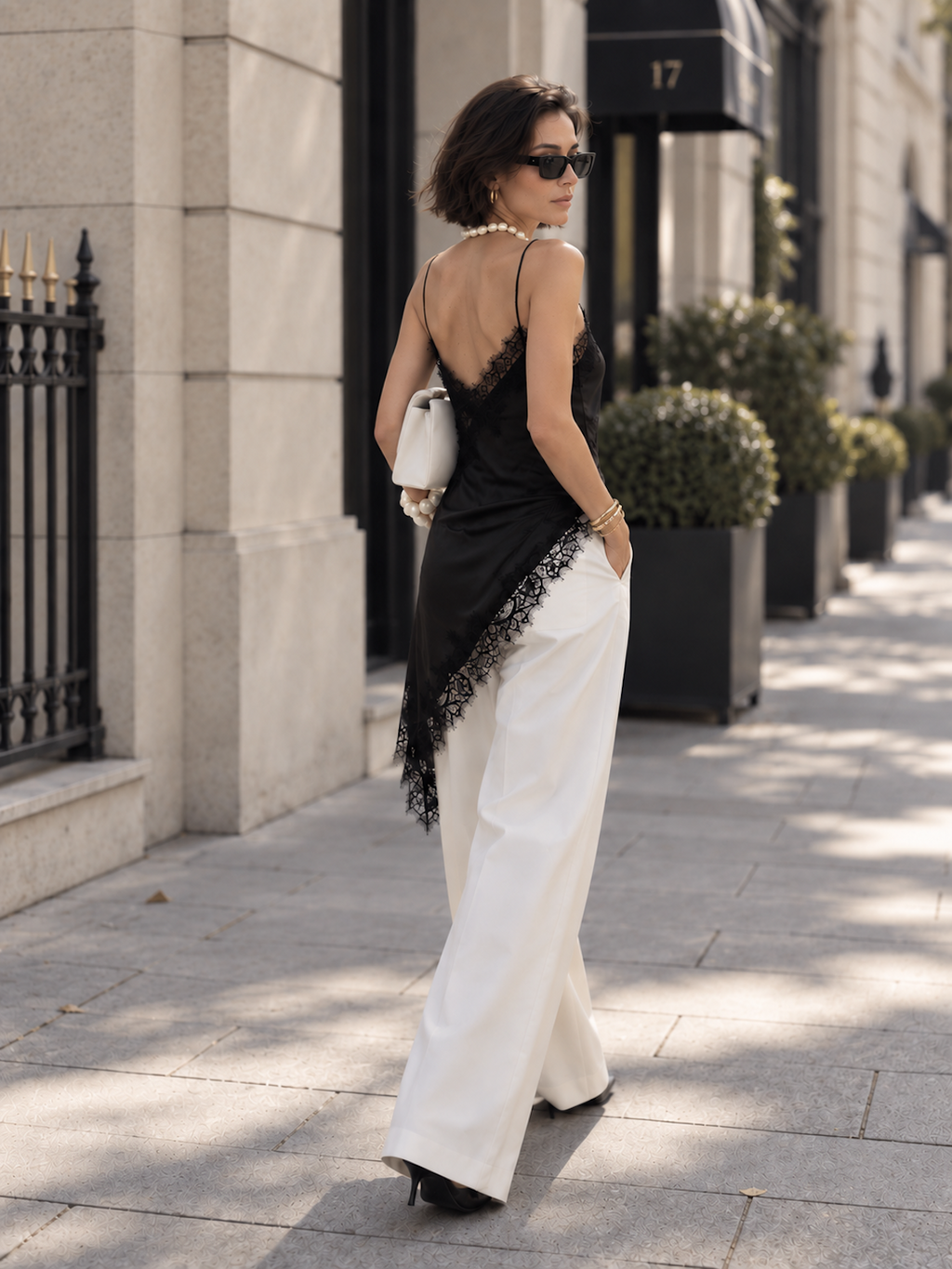 Back view of the Light Yellow Elévaison Renata Sleeveless Top with slim straps and lace-trimmed asymmetric hem in studio.