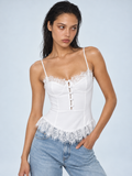 Elévaison Belle Tank Top in white, close-up front view showing lace trim, shaped cups and front button detail against a pale blue studio background.