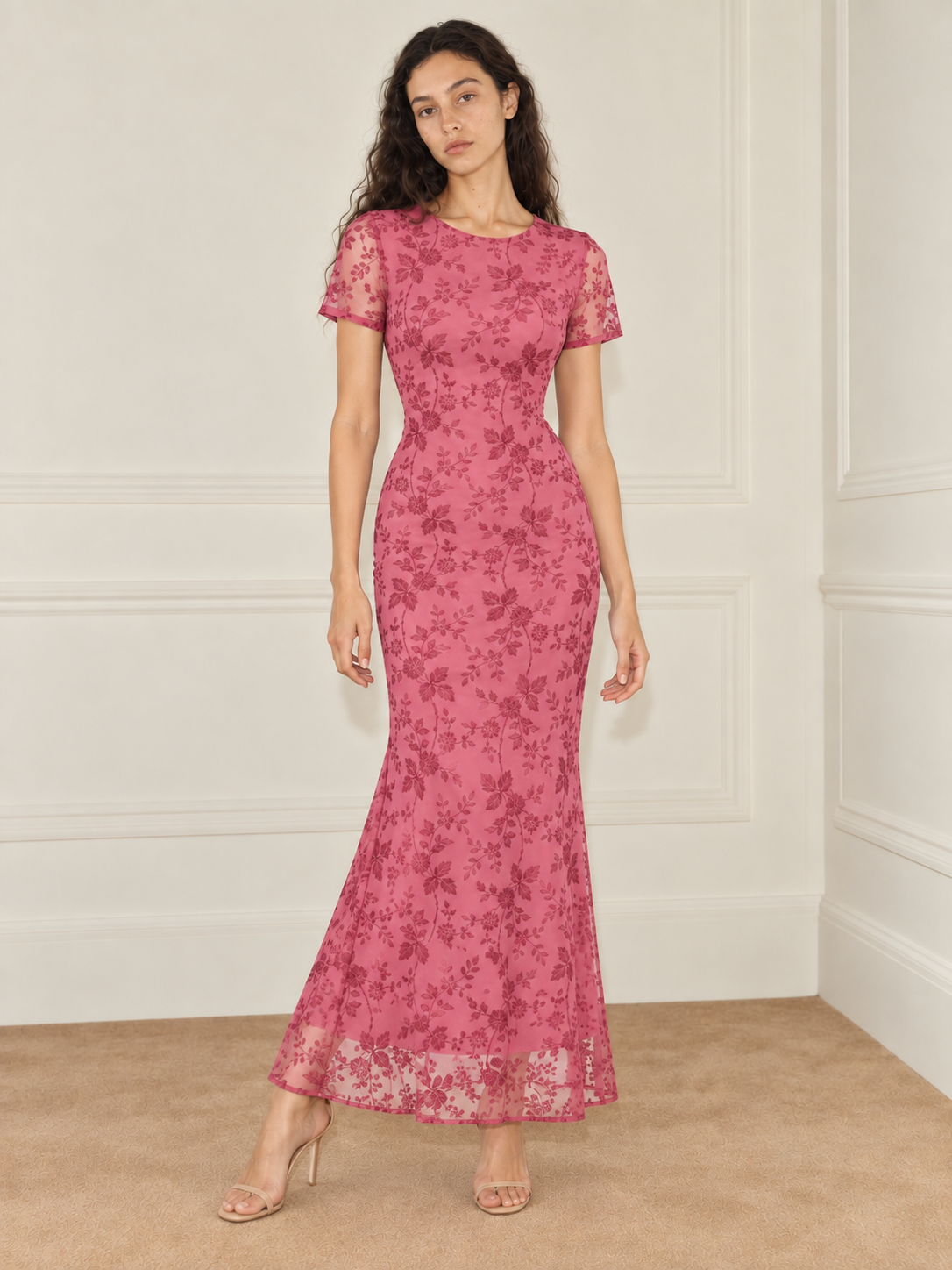 Elévaison Juliette Dress in pink, full-length front view showing a fitted silhouette, short sheer sleeves and sheer floral hem against a warm cream paneled studio background.