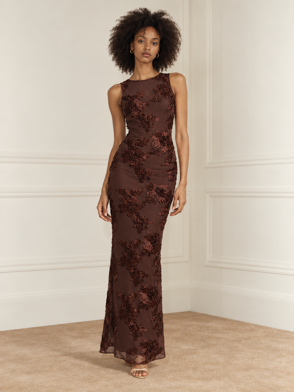 Elévaison Grace Dress in chocolate brown, full-length front view showing a sleeveless fitted silhouette and dimensional floral embroidery against a warm cream paneled studio background.