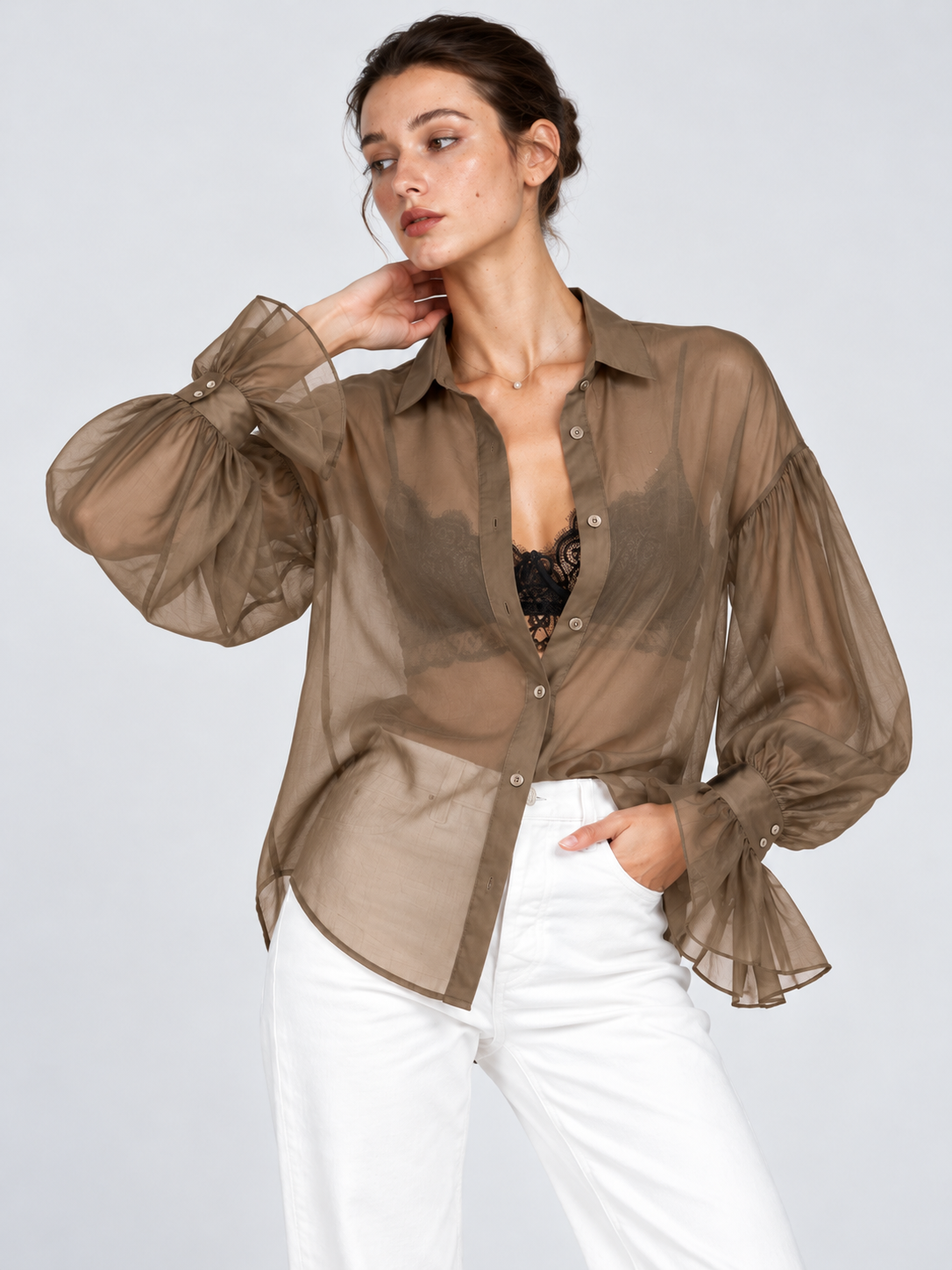 A closer view of the Elévaison Florence Blouse in Khaki shows balloon sleeves and ruffled cuffs against a light gray backdrop.