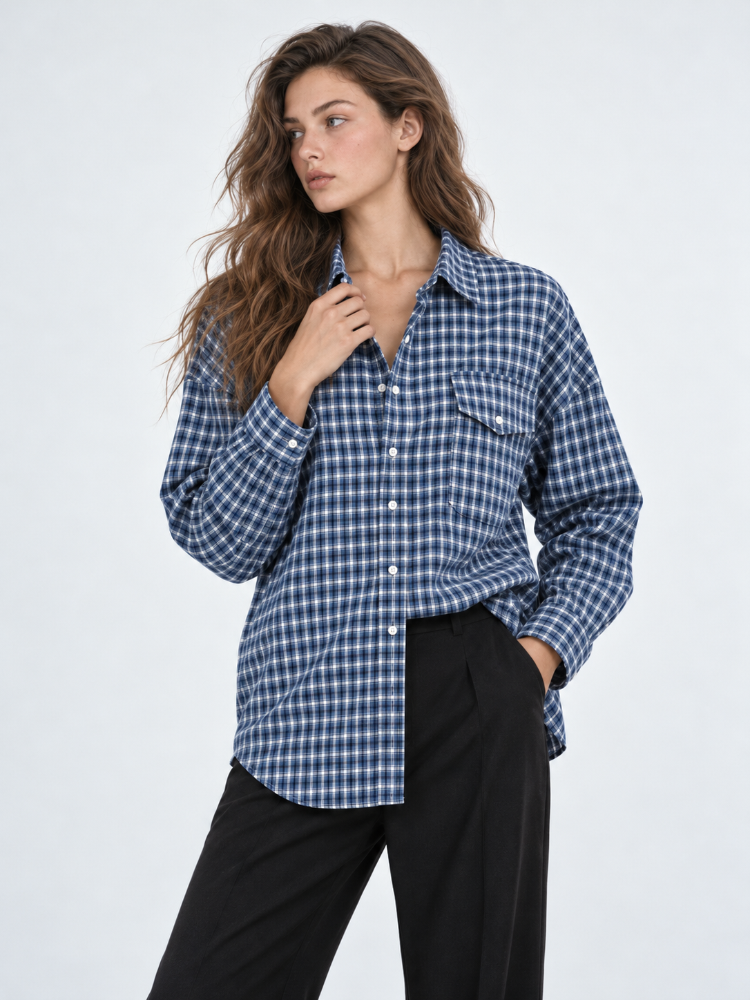 A closer view of the Elévaison Audrey Cotton Shirt in Twilight Check shows its pointed collar and chest pockets against a gray backdrop.