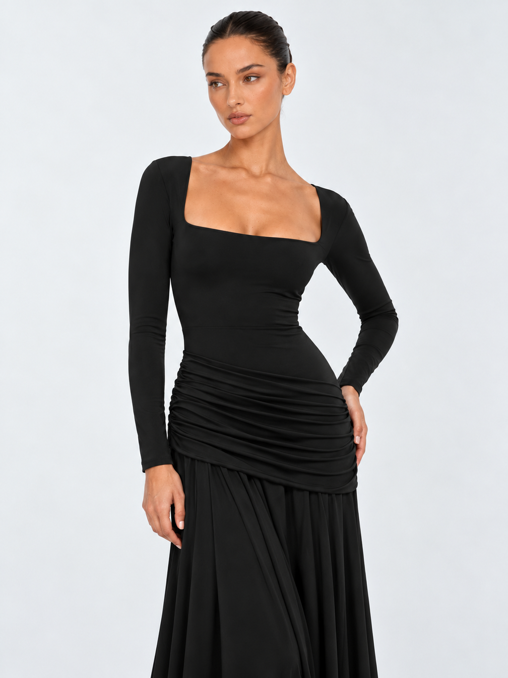 A closer view of the Elévaison Arabella Dress in Black shows its square neckline and long fitted sleeves against a light gray backdrop.