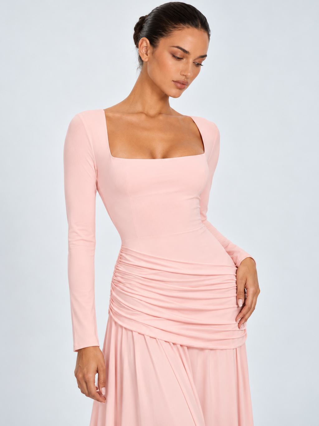 A closer view of the Elévaison Arabella Dress in Pink shows its square neckline and softly ruched hips against a gray backdrop.