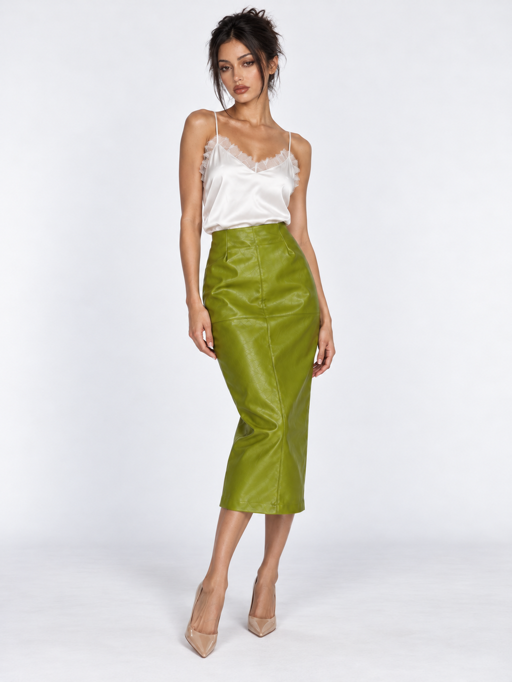 A model wears the Elévaison Anya Silk Camisole in White with a green midi skirt against a light gray studio backdrop.